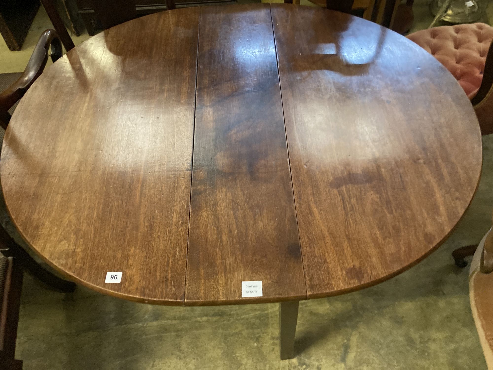 A George III mahogany cottage drop leaf dining table, width 106cm, length 128cm extended, height 70cm